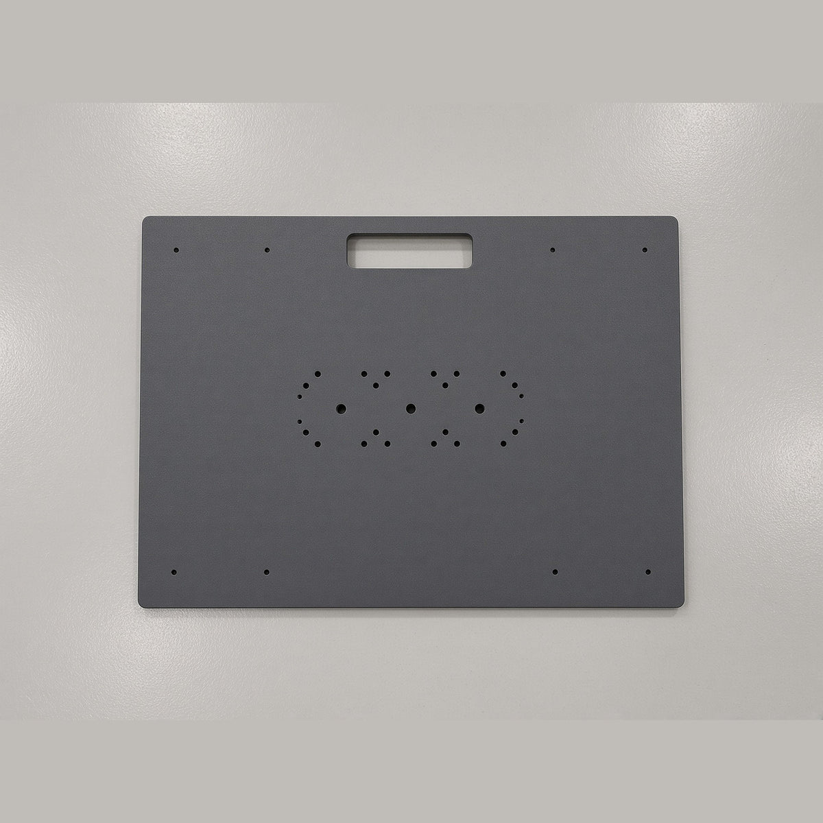 Top of the Travel Platform showing the dock mounting hole pattern and carry handle cutout